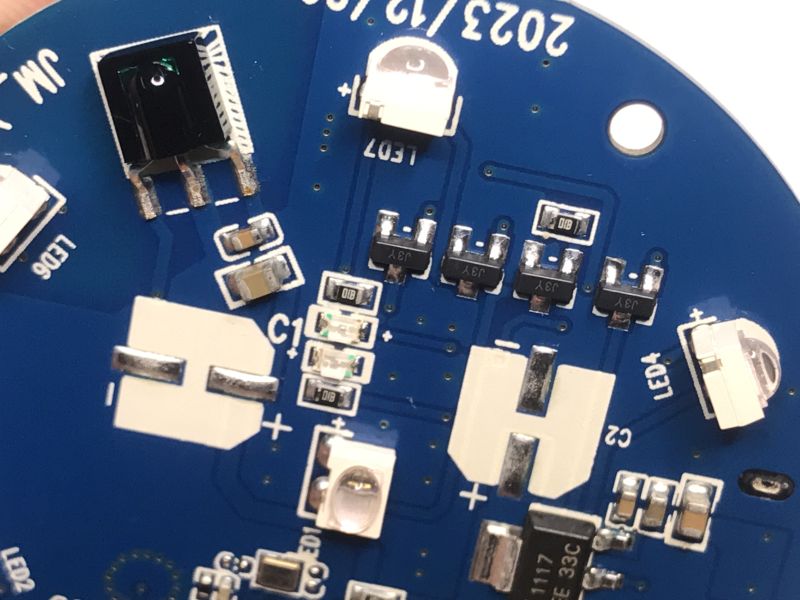 Close-up of PCB with IR components, transistors, and status LEDs.