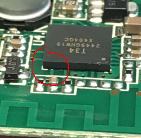 QFN chip on PCB with unconnected pad marked Close-up of QFN chip on PCB with exposed pads, one area marked with red circle.