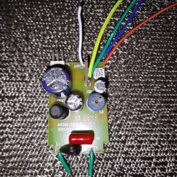 A circuit board with electronic components and four soldered wires.