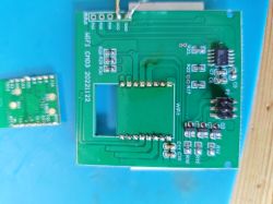 Two printed circuit boards: one larger with a socket for a module, and a smaller one partly out of frame.