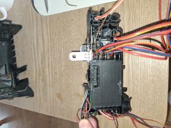Electronic component with colorful wires on a wooden table.