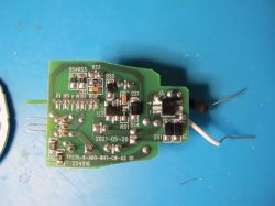 Printed circuit board with electronic components on a blue background.