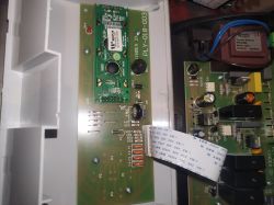 Zdjęcie wnętrza sterownika pieca Defro na ekogroszek z widocznymi płytkami elektronicznymi i podłączonym przewodem.