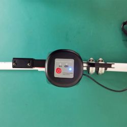 Tokatuker Remote Water Valve Controller Remote water valve controller mounted on a white pipe.