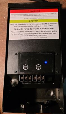 Low-voltage transformer housing with warning panel and control buttons.