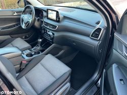 Car interior showing dashboard, steering wheel, and navigation screen with map