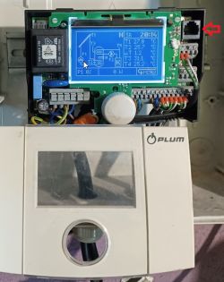 Plum controller with connected RJ11 cable, screen displays temperature parameters.