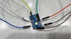 Electronic Module with Wires Electronic module with multiple colored wires attached on a light background.