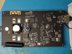 PCB with electronic components and Wi-Fi module on a blue background