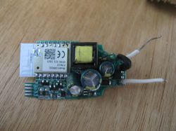 Circuit board with electronic components on a wooden background.