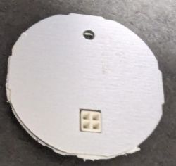 Electronic Module with Small Connector Image of a round electronic module board with a small connector in the center.