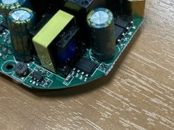 Close-up of a printed circuit board with electronic components such as capacitors and coils.