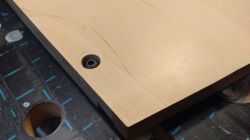 Screw in Wooden Board Close-up of a wooden board corner with a screw.