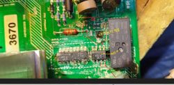 The photo shows a circuit board with electronic components and handwritten notes.