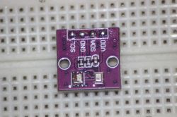 Electronic module with labels SCL, GND, SDA, VDD on a breadboard