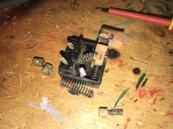 Dismantled Vintage Drill Switch Dismantled drill switch on a wooden table.