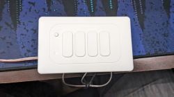 Wall Switch with Four Buttons White wall switch with four buttons and an LED indicator.