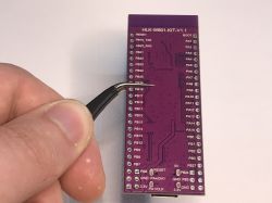 HLK-W801-KIT-V1.1 Development Board HLK-W801-KIT-V1.1 development board held by a person using tweezers.