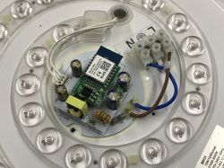 Electronic module in an LED lamp with visible circuit board and components.
