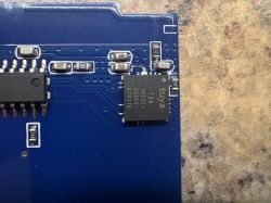 Section of a blue circuit board with SMD components and ICs Close-up of a blue PCB with IC chips and SMD resistors and capacitors