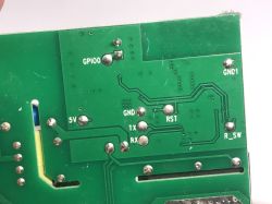 Close-up of a PCB with pin labels: GPIO0, GND, RST, RX, TX, 5V, GND1, R_SW.