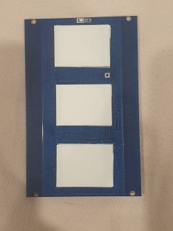 Close-up of a circuit board with three white rectangles on a blue background.