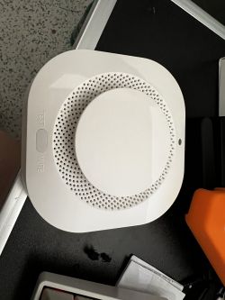 Optical Smoke Detector with Visible Panel Optical smoke detector on a desk with TEST and MUTE buttons.