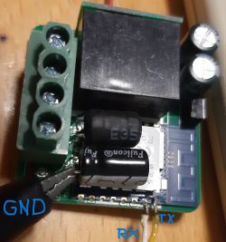 Close-up of a circuit board with marked TX, RX, and GND points.