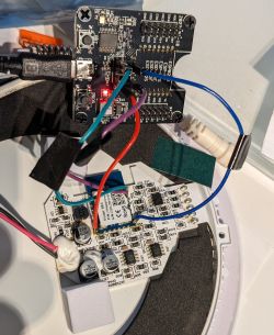 Electronic module with soldered wires connected to a programmer.
