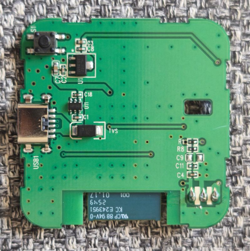 Green PCB with USB‑C port, push button, SMD components, and a rectangular cutout.