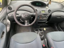 Interior of a Toyota car with visible steering wheel and dashboard.