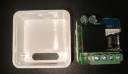 Opened device showing plastic casing and circuit board with electronic components.