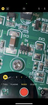Zbliżenie na płytkę PCB z układem oznaczonym jako PA0 oraz elementami SMD, widoczne uszkodzenie kondensatora.
