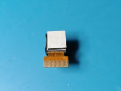 Electronic module with ribbon connector on a blue background