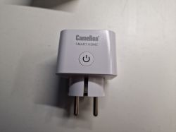 White smart plug Camelion with a visible power button in the center.