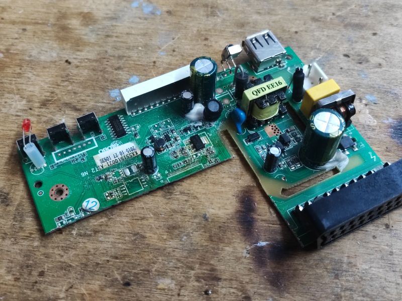 Two PCB Boards with Electronic Components Two PCB boards with various electronic components on a wooden surface.