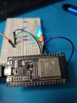 ESP32 board connected to three LEDs on a breadboard.