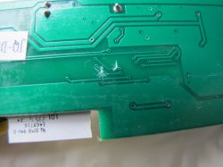 Underside of Circuit Board with Removed Trace Close-up view of the underside of a circuit board with a removed copper trace.