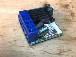 WSM16-W1 relay module with visible electronic components, including a relay, capacitors, and a terminal block.