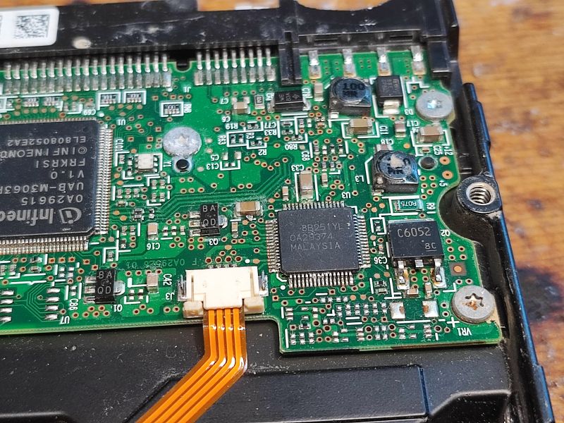 Hard Drive PCB Electronics 3.5 Hitachi Close-up of a hard drive PCB with integrated circuits.
