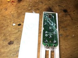 Interior of the remote control with visible PCB and buttons.