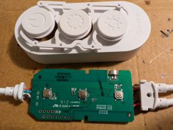 Disassembled LED controller housing with visible PCB and buttons.