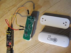 TH01 Sensor with Connected Wires TH01 temperature and humidity sensor with connected wires on a wooden floor background.