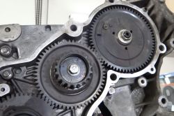Close-up of engine injection pump gears with visible alignment markings.