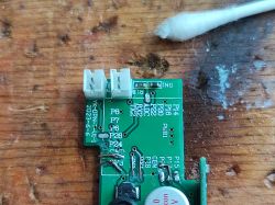 Close-up of a circuit board with visible connectors, traces, and markings.
