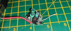 The image shows a small circuit board with wires attached to components.