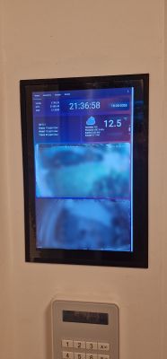 Dotykowy ekran w ścianie z panelem Home Assistant i dwoma podglądami kamer