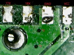 Close-up of a two-layer PCB with markings TX, RX, GND, and VCC, and vias labeled *1, *2, and *3.