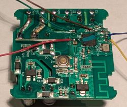 Close-up of a circuit board with electronic components and soldered wires