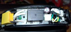 Interior of a damaged electric kettle showing electronic components.
